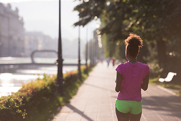 Image showing Black woman doing warming up and stretching