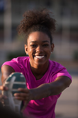 Image showing African American woman doing warming up and stretching