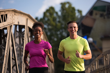 Image showing multiethnic couple jogging in the city