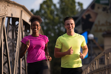 Image showing multiethnic couple jogging in the city