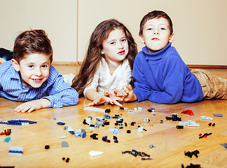 Image showing funny cute children playing lego at home, boys and girl smiling, first education role lifestyle