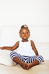 Image showing little pretty african american girl sitting in white chair weari