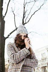 Image showing young pretty stylish modern hipster girl outside on street, fash