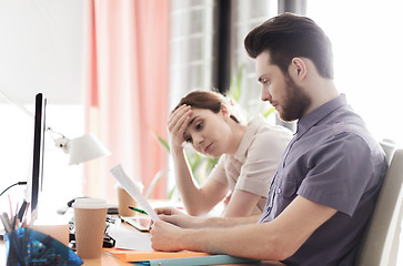 Image showing creative team with reading paper in office