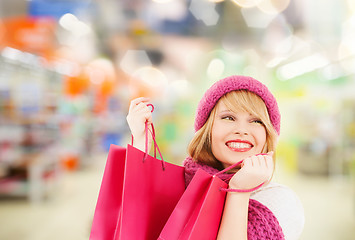 Image showing woman in hat and scarf shopping at supermarket