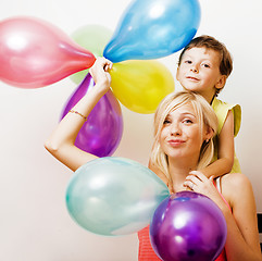 Image showing pretty real family with color balloons on white background, blon