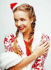 Image showing young pretty happy smiling blond woman on christmas in santas red hat and holiday decorated plaid, lifestyle people concept