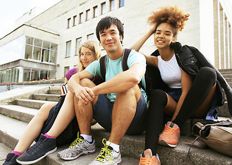 Image showing cute group of teenages at the building of university with books 