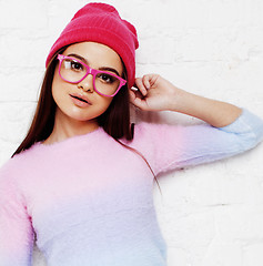 Image showing pretty young teenage girl hipster in pink glasses and hat emotional posing happy smiling, lifestyle people concept