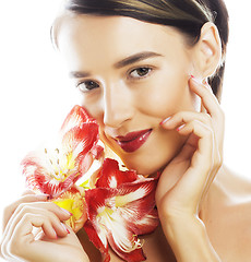 Image showing young pretty brunette woman with red flower amaryllis close up i