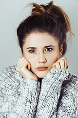 Image showing young pretty woman in sweater and scarf all over her face, winte