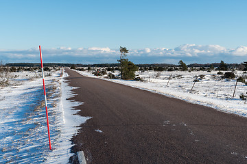 Image showing Snow stake by a country road side in a plain landscape