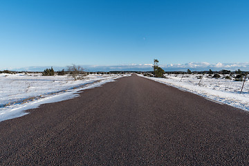 Image showing Winter scene from a straight road through a great plain landscap