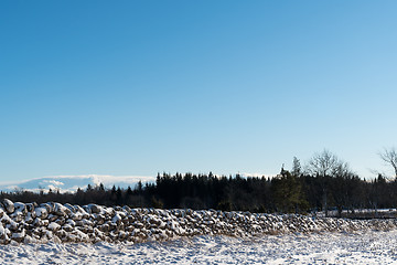 Image showing Landscape with snow covered stone wall