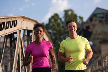 Image showing multiethnic couple jogging in the city