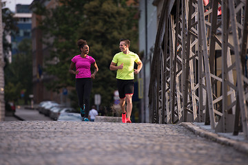 Image showing multiethnic couple jogging in the city