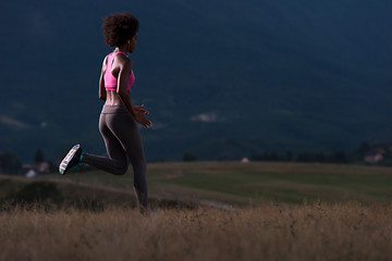 Image showing Young African american woman jogging in nature