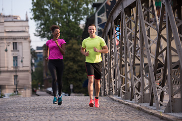 Image showing multiethnic couple jogging in the city