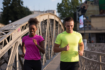 Image showing multiethnic couple jogging in the city