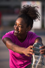 Image showing African American woman doing warming up and stretching