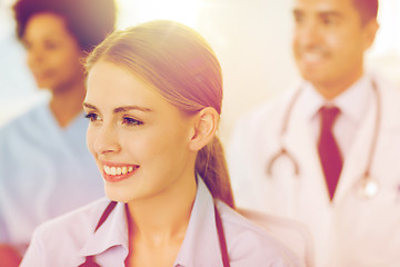 Image showing happy doctor over group of medics at hospital