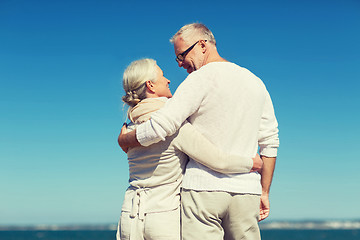 Image showing happy senior couple hugging on summer beach