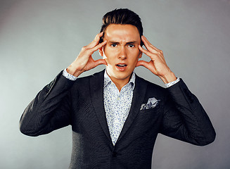 Image showing young pretty business man standing on white background, modern hairstyle, posing emotional, lifestyle people concept