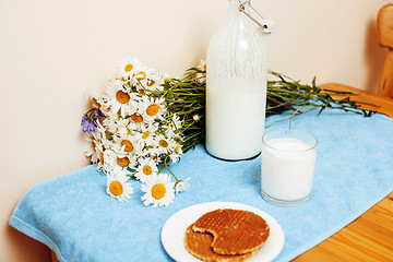 Image showing Simply stylish wooden kitchen with bottle of milk and glass on t