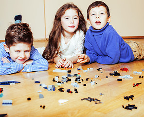 Image showing funny cute children playing lego at home, boys and girl smiling, first education role lifestyle