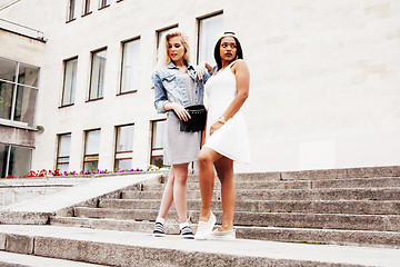 Image showing Two teenage girls infront of university building smiling, having