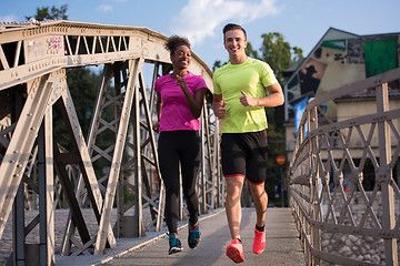 Image showing multiethnic couple jogging in the city