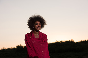 Image showing outdoor portrait of a black woman with a scarf