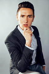 Image showing young pretty business man standing on white background, modern hairstyle, posing emotional, lifestyle people concept