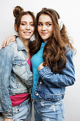 Image showing lifestyle and people concept: Fashion portrait of two stylish sexy girls best friends, over white background. Happy time for fun.