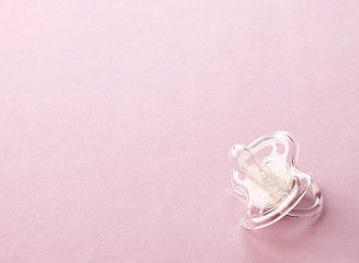 Image showing transparent pacifier on pink background