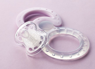 Image showing transparent pacifier on pink background