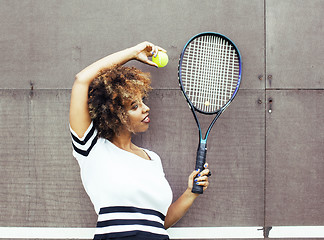 Image showing young stylish mulatto afro-american girl playing tennis, sport healthy lifestyle people concept