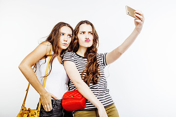 Image showing two best friends teenage girls together having fun, posing emotional on white background, besties happy smiling, making selfie, lifestyle people concept