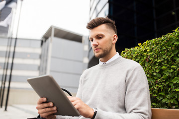 Image showing man with tablet pc sitting on city street bench