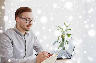 Image showing creative man or businessman writing to notebook