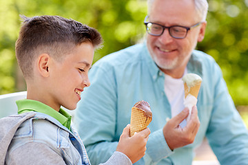 Image showing old man and boy eating ice cream at summer park