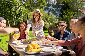 Image showing happy friends having dinner at summer garden party