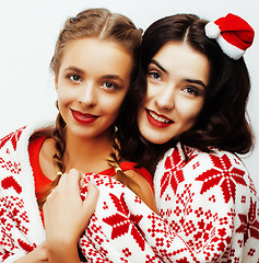 Image showing young pretty happy smiling blond and brunette woman girlfriends on christmas in santas red hat and holiday decorated plaid, lifestyle people concept