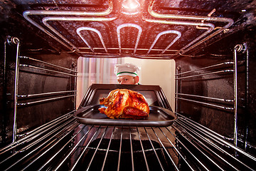 Image showing Cooking chicken in the oven.