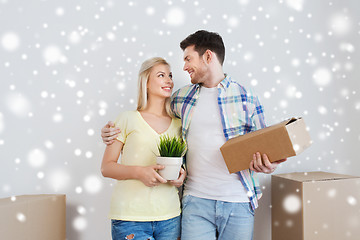 Image showing smiling couple with boxes moving to new home