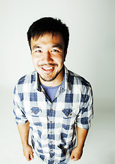 Image showing young cute asian man on white background gesturing emotional, po