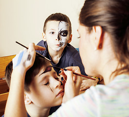 Image showing little cute child making facepaint on birthday party, zombie Apo