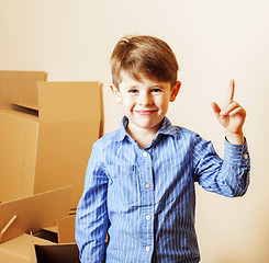 Image showing little cute boy in empty room, remoove to new house. home alone,