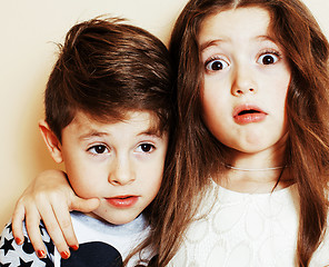 Image showing little cute boy and girl hugging playing on white background, ha