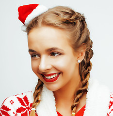 Image showing young pretty happy smiling blond woman on christmas in santas red hat and holiday decorated plaid, lifestyle people concept